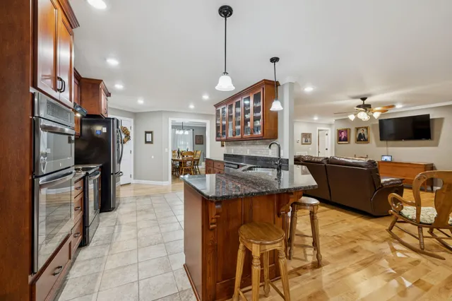 a cabinet with granite countertop lots of different kinds of food