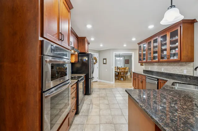 a dining room with furniture a rug and wooden floor