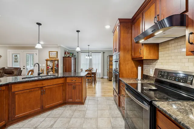 a dining room with furniture a rug and wooden floor