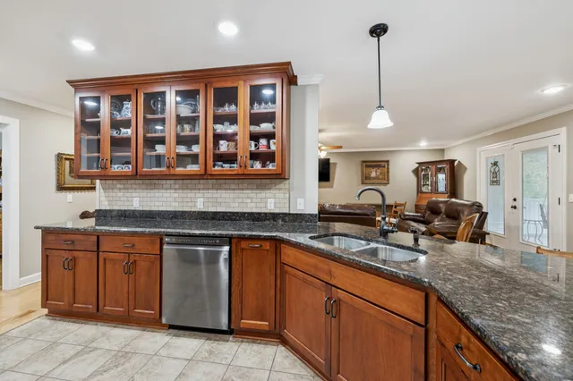 a bed room with a bed a television and dresser
