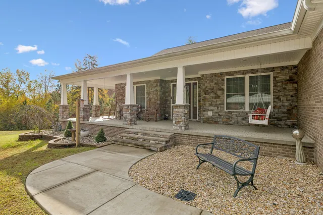 a living room with furniture kitchen view and a flat screen tv