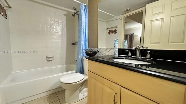 a bathroom with a granite countertop sink toilet a mirror and shower