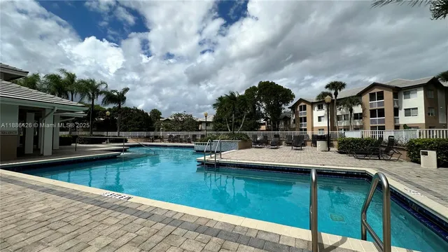 a view of a swimming pool with a chair and tables