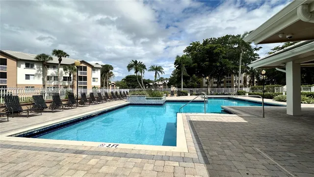 a view of a swimming pool with lounge chair