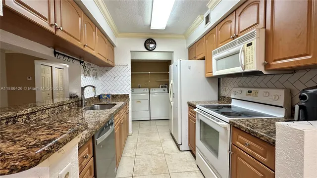 a kitchen with stainless steel appliances granite countertop a stove and a sink