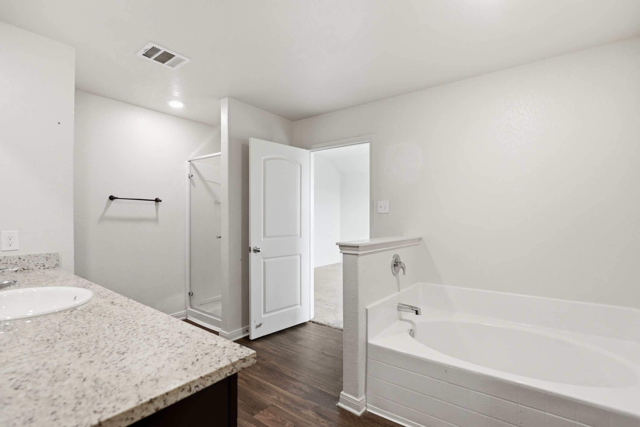 300 Hyacinth Way Jarrell, TX 76537 - Photo 26 of 37 a bathroom with a granite countertop sink and a bathtub