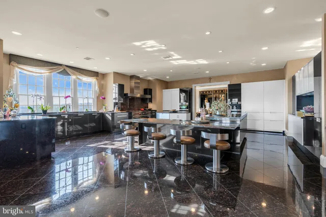 a kitchen with lots of counter top space a sink appliances and cabinets
