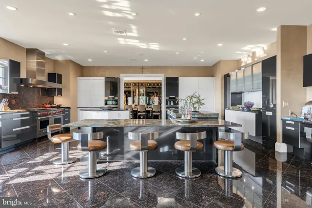 a living room with lots of furniture and kitchen view