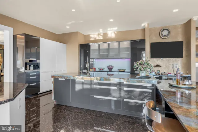 a kitchen with stainless steel appliances kitchen island granite countertop a sink and cabinets