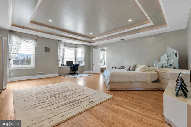 a large spacious bathroom with a tub a double vanity sink and a large mirror