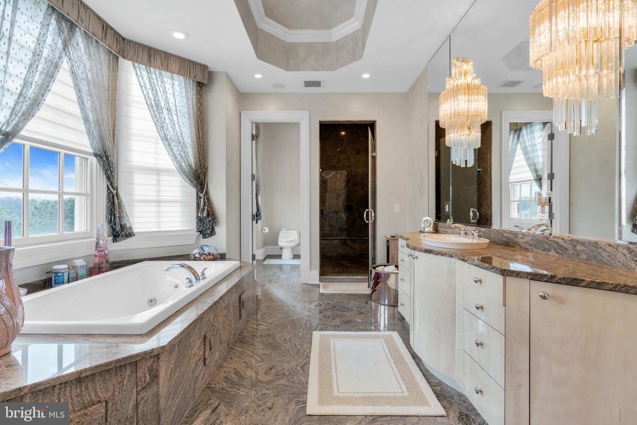 1041 Oval Road Manasquan, NJ 08736 - Photo 21 of 30 a large spacious bathroom with a tub a double vanity sink and a large mirror
