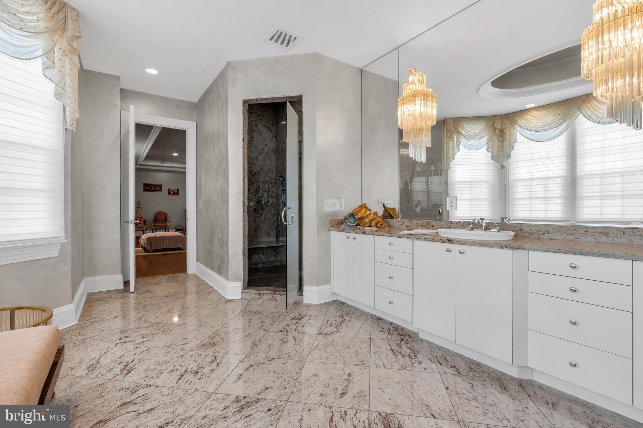 1041 Oval Road Manasquan, NJ 08736 - Photo 23 of 30 a spacious bathroom with a double vanity sink and a mirror