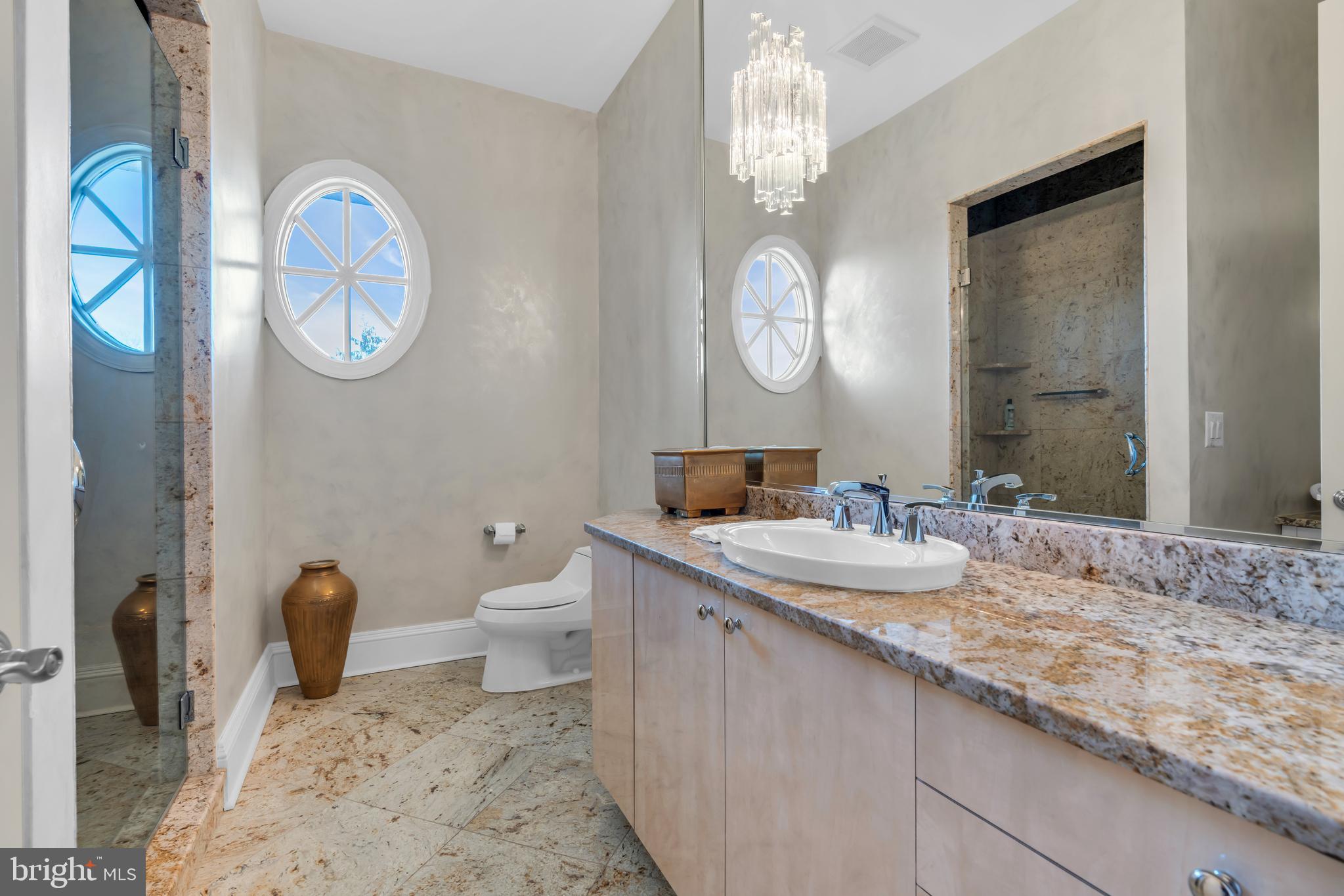 1041 Oval Road Manasquan, NJ 08736 - Photo 25 of 30 a bathroom with a granite countertop toilet a sink and a mirror