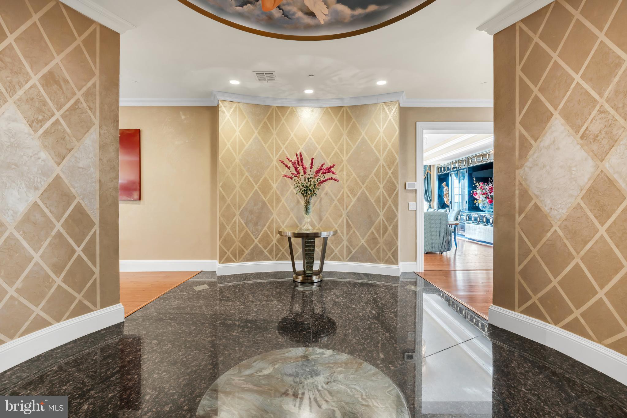 1041 Oval Road Manasquan, NJ 08736 - Photo 4 of 30 a view of a hallway with wooden floor and a potted plant