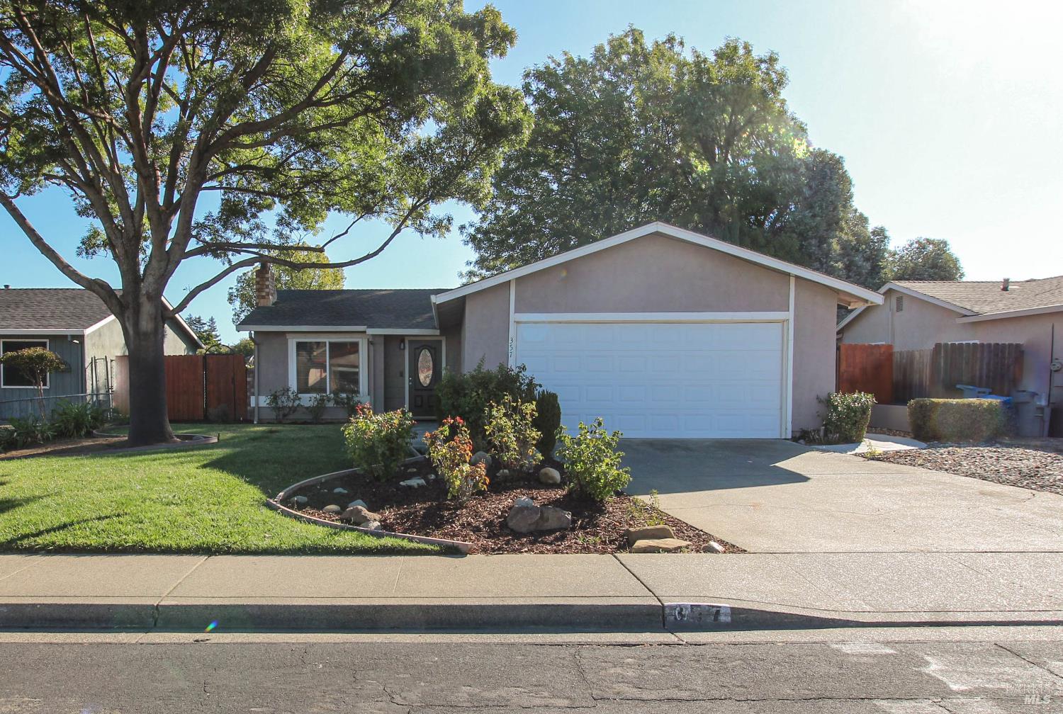 357 Colonial Circle Vacaville, CA 95687 - Photo 1 of 1 a front view of a house with a yard and garage