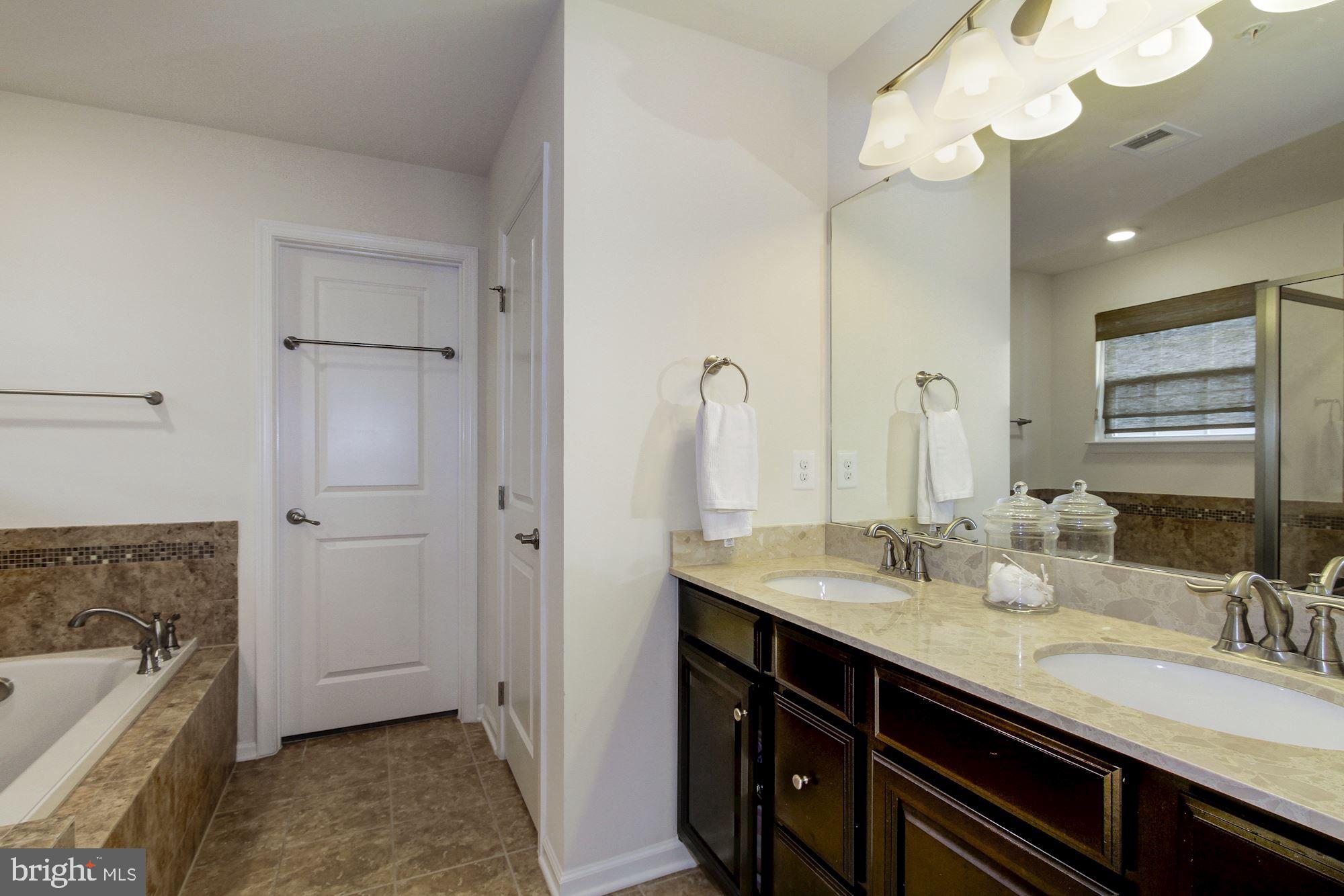 13747 Soaring Wing Lane Silver Spring, MD 20906 - Photo 15 of 27 Master Bath with tiled bath, shower, double sinks