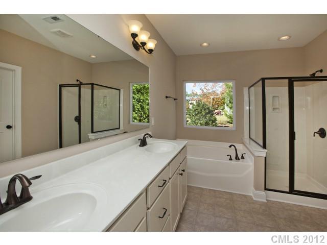 86593 Arrington Road, Unit 102 Lancaster, SC 29720 - Photo 11 of 15 a bathroom with a tub sink and mirror