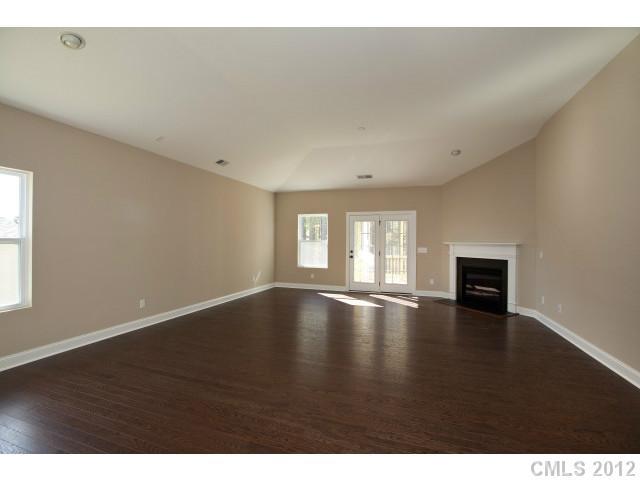 86593 Arrington Road, Unit 102 Lancaster, SC 29720 - Photo 5 of 15 a view of empty room with wooden floor and fan