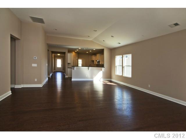 86593 Arrington Road, Unit 102 Lancaster, SC 29720 - Photo 6 of 15 a view of an empty room with wooden floor and a window