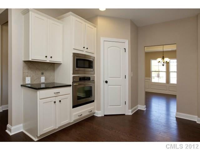 86593 Arrington Road, Unit 102 Lancaster, SC 29720 - Photo 7 of 15 a kitchen with granite countertop white cabinets and stainless steel appliances