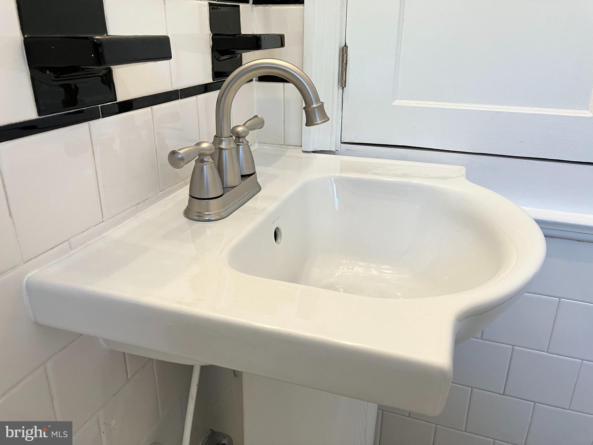 4818 Coleherne Road Baltimore, MD 21229 - Photo 19 of 20 Quality sink and fixture in your hall bath.
