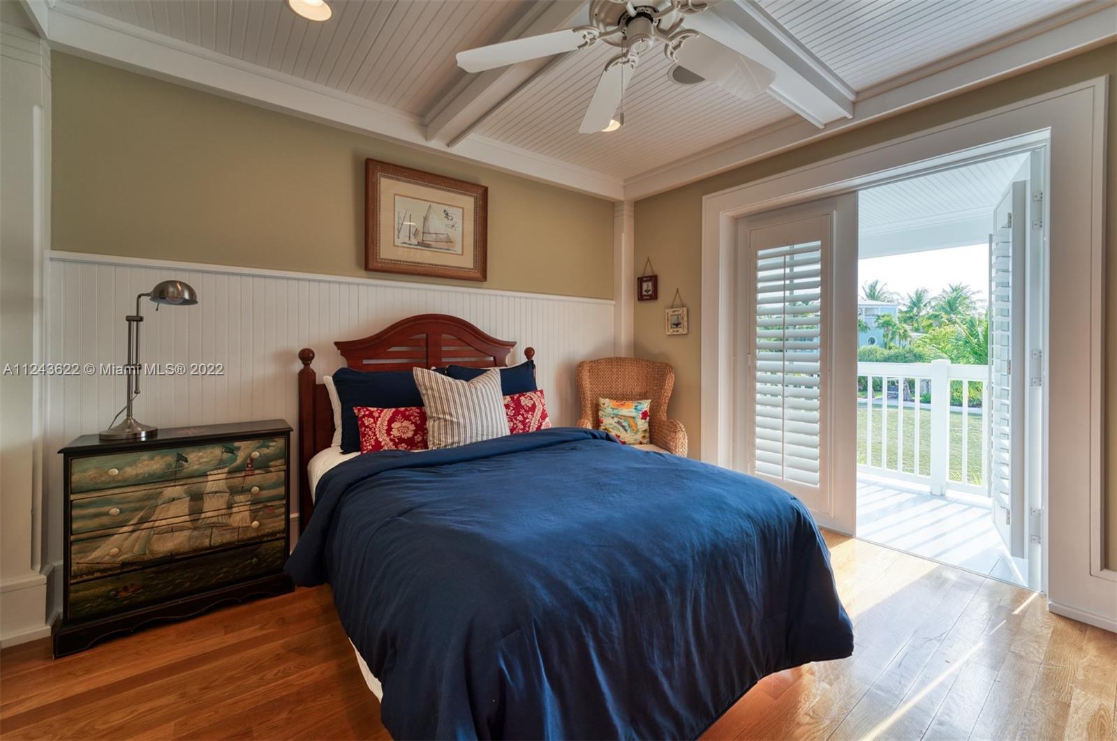 32 Sunset Key Drive Key West, FL 33040 - Photo 16 of 49 a bedroom with a bed and wooden floor