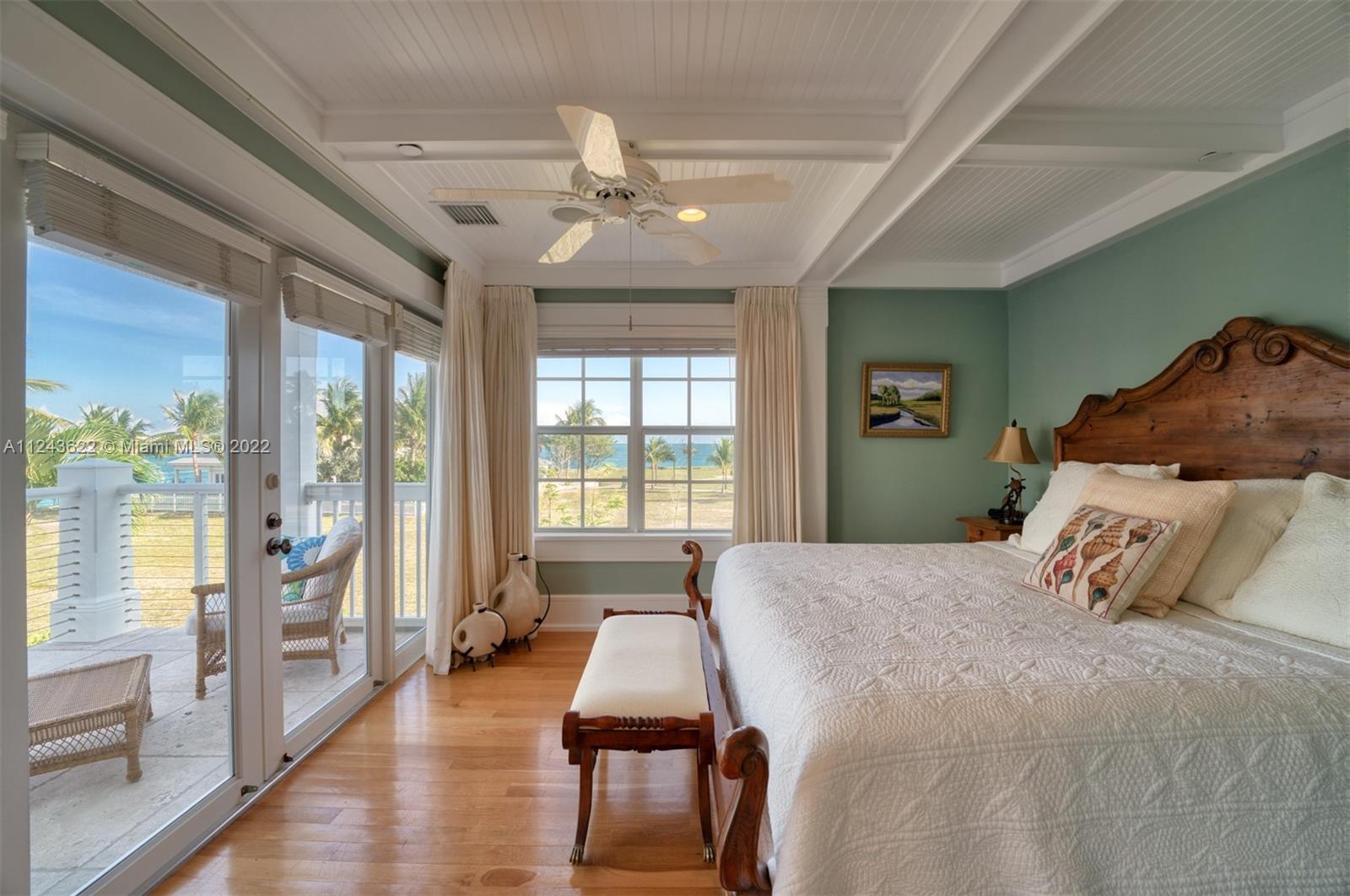 32 Sunset Key Drive Key West, FL 33040 - Photo 21 of 49 a spacious bedroom with a bed and wooden floor