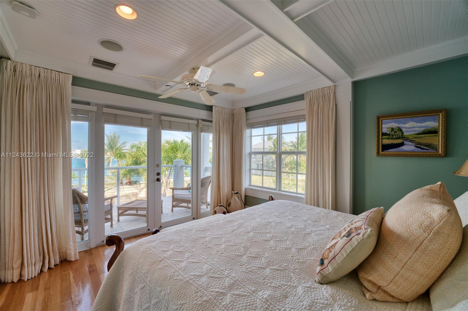 32 Sunset Key Drive Key West, FL 33040 - Photo 22 of 49 a bedroom with a large bed and a large window