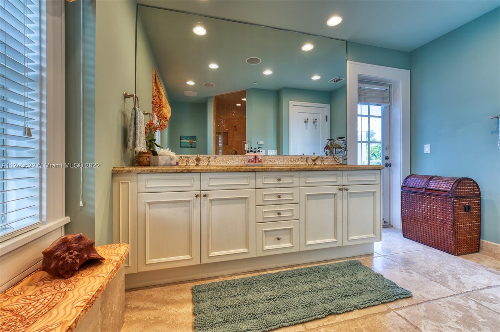 32 Sunset Key Drive Key West, FL 33040 - Photo 23 of 49 a spacious bathroom with a granite countertop sink and a mirror