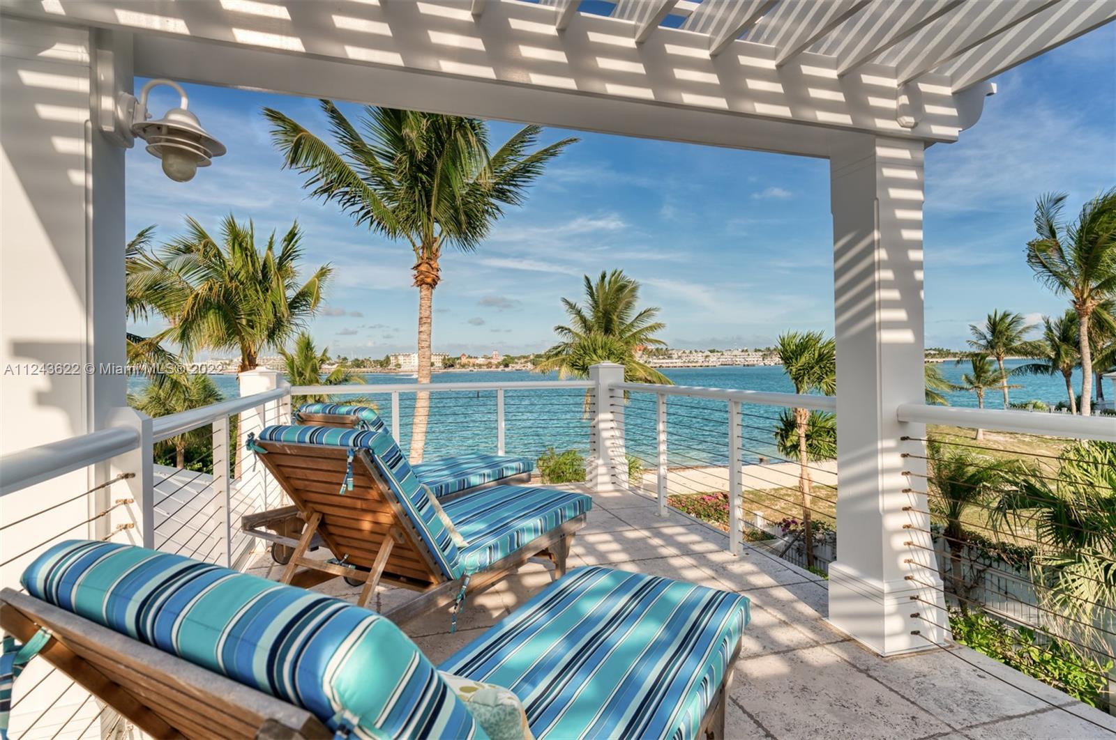 32 Sunset Key Drive Key West, FL 33040 - Photo 26 of 49 a view of a patio with table and chairs potted plants with wooden floor