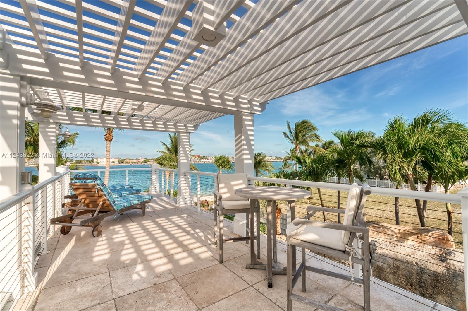 32 Sunset Key Drive Key West, FL 33040 - Photo 27 of 49 a view of a patio with table and chairs and potted plants