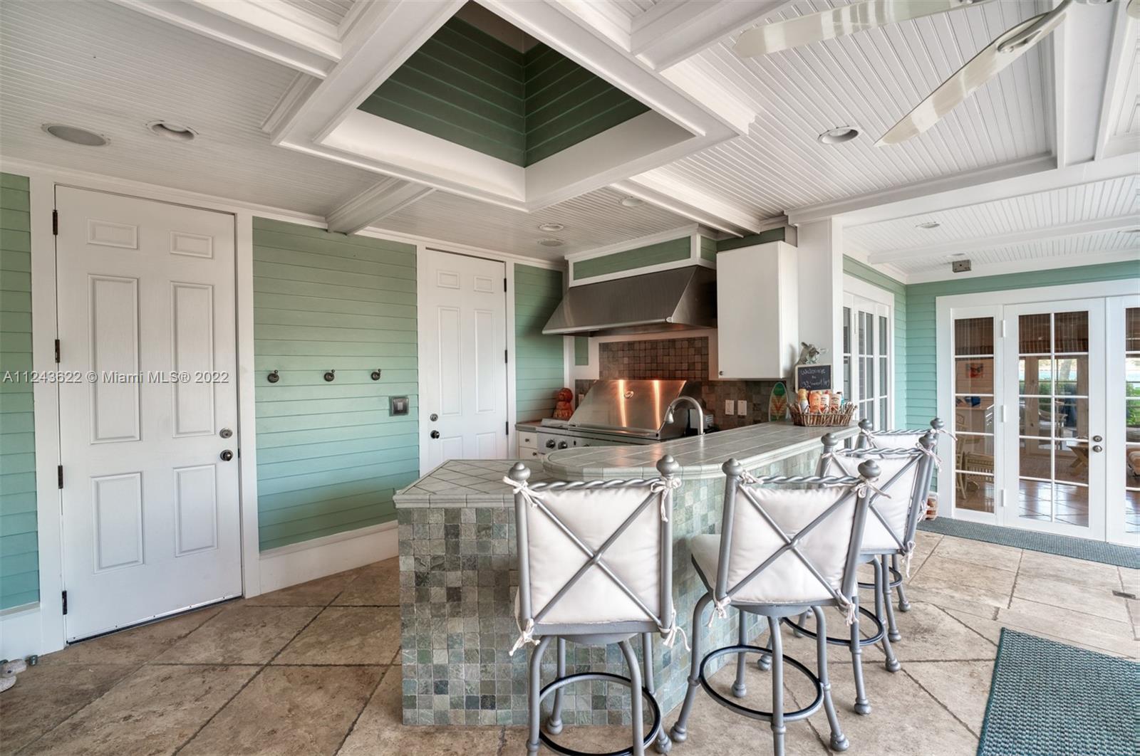 32 Sunset Key Drive Key West, FL 33040 - Photo 32 of 49 a kitchen with a table chairs refrigerator and cabinets
