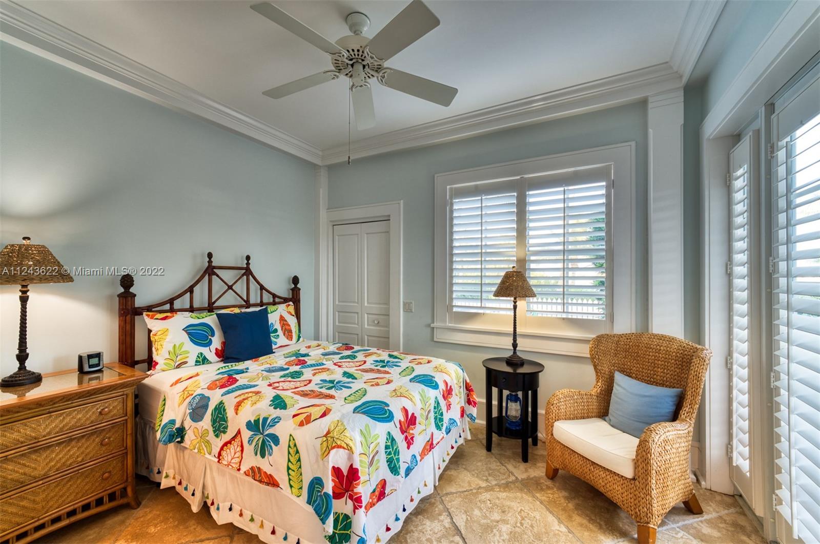 32 Sunset Key Drive Key West, FL 33040 - Photo 38 of 49 a bedroom with a bed and wooden floor