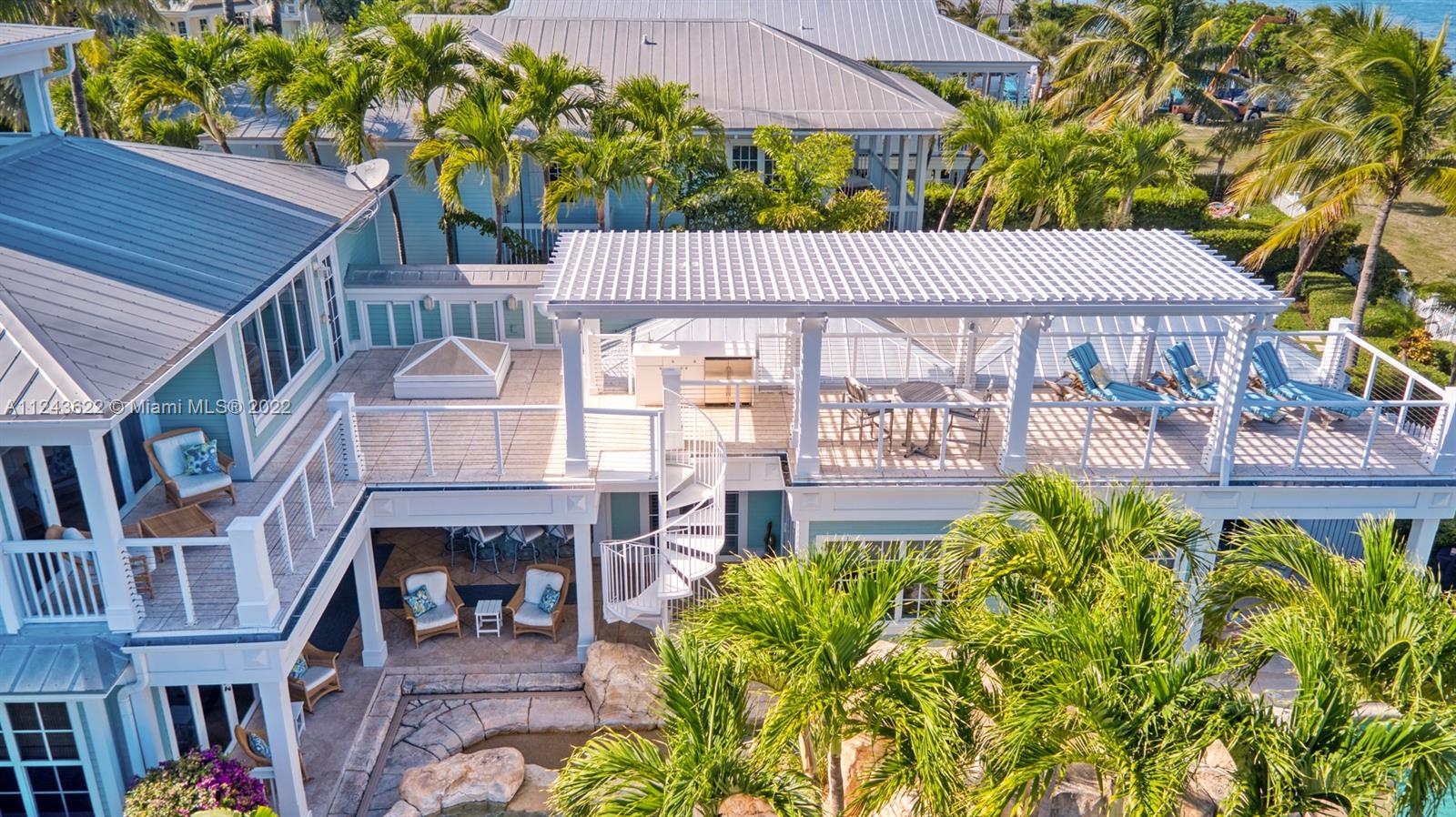 32 Sunset Key Drive Key West, FL 33040 - Photo 43 of 49 a view of a patio with table and chairs and potted plants