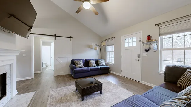 a living room with furniture and a fireplace