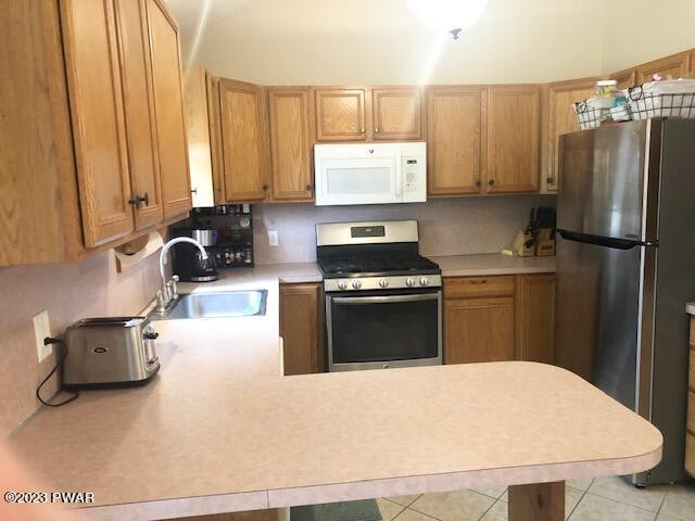 113 Beecher Road Dingmans Ferry, PA 18328 - Photo 6 of 24 a kitchen with a refrigerator and a stove