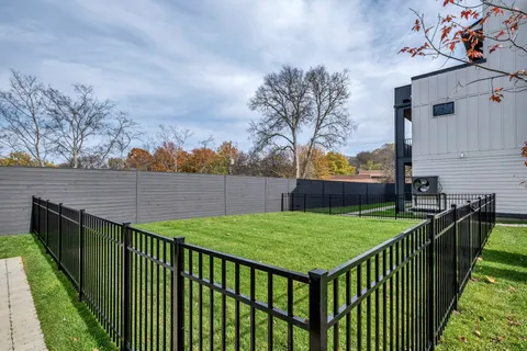 a view of backyard with table and chairs and potted plants