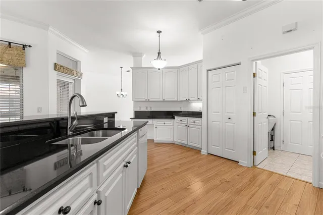 a kitchen with granite countertop a sink stove and cabinets