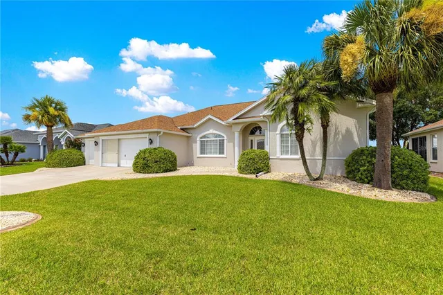 a view of a house with a swimming pool and a yard
