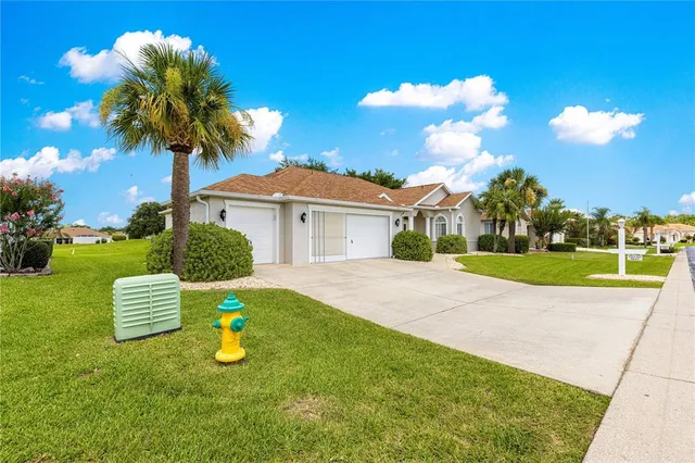 a view of a house with palm trees