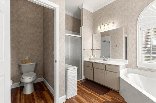 a spacious bathroom with a toilet sink and mirror