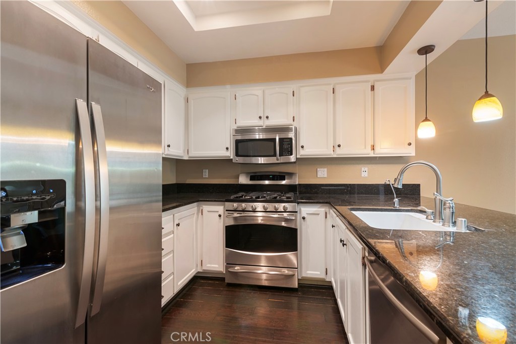 27726 Rubidoux Mission Viejo, CA 92692 - Photo 11 of 31 a kitchen with stainless steel appliances granite countertop a stove a refrigerator and a sink