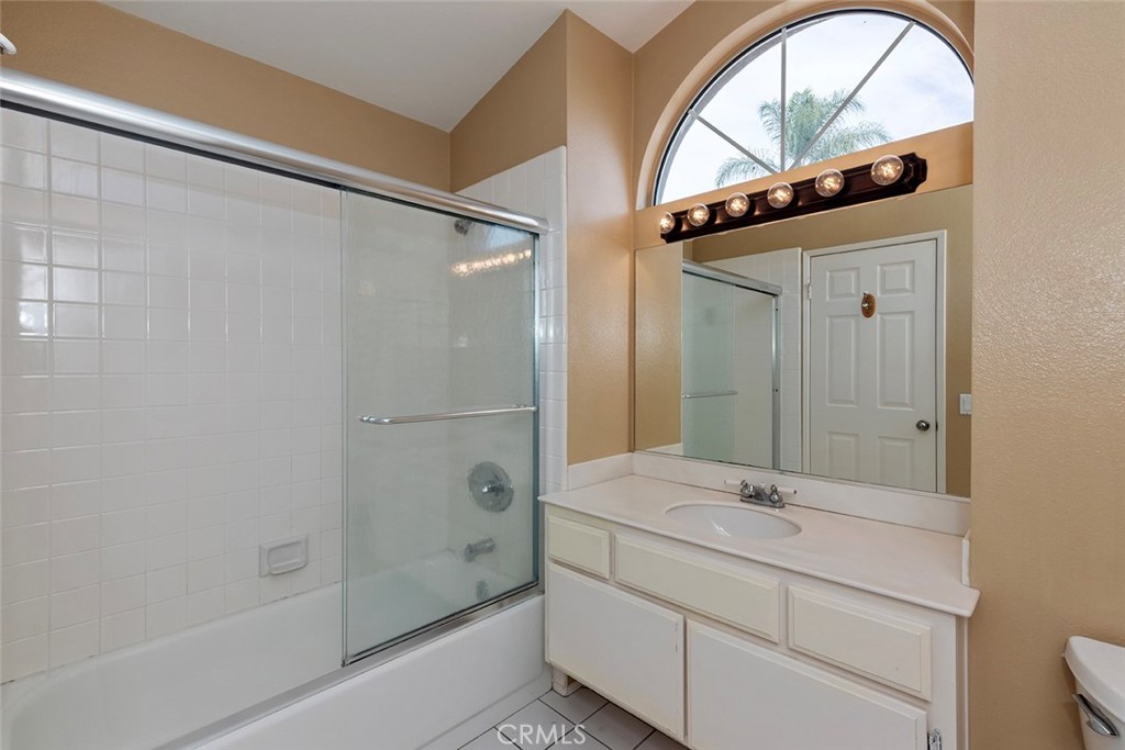 27726 Rubidoux Mission Viejo, CA 92692 - Photo 20 of 31 a bathroom with a granite countertop sink a mirror and a bathtub