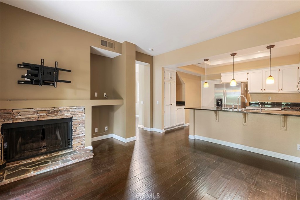 27726 Rubidoux Mission Viejo, CA 92692 - Photo 21 of 31 a view of a kitchen with a sink a fireplace and wooden floor