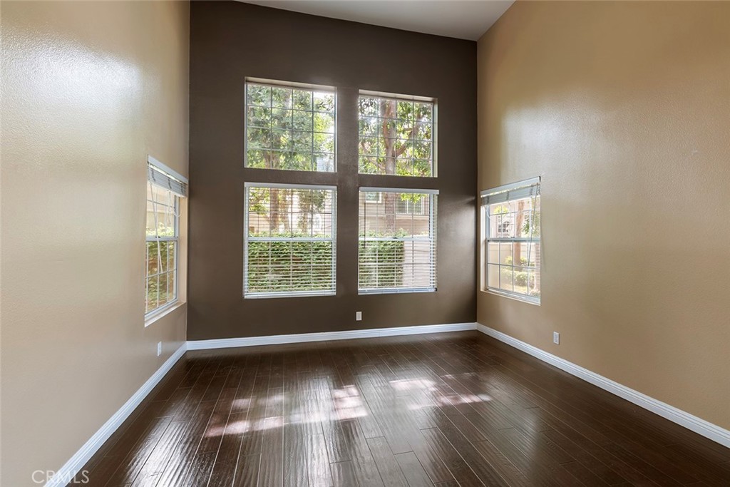27726 Rubidoux Mission Viejo, CA 92692 - Photo 5 of 31 an empty room with wooden floor and windows