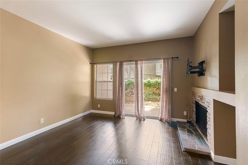 27726 Rubidoux Mission Viejo, CA 92692 - Photo 9 of 31 an empty room with fireplace and wooden floor