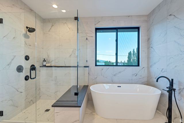 2145 North Main Street Centerville, UT 84014 - Photo 33 of 53 Full bathroom with a freestanding bath, a marble finish shower, tile walls, and marble tiled flooring