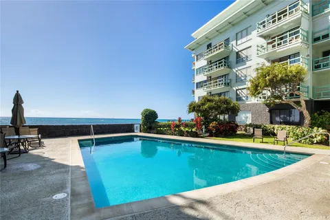 a swimming pool view with a outdoor seating