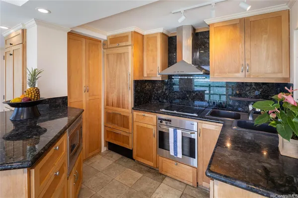 a kitchen with stainless steel appliances granite countertop a sink stove and refrigerator