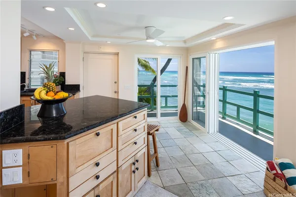 a kitchen with stainless steel appliances granite countertop a sink and a stove